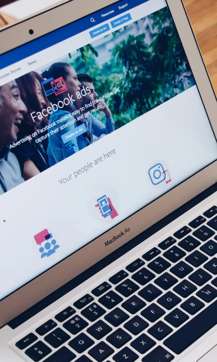 MacBook screen displaying a Facebook Ads manager interface for social media marketing and targeting.