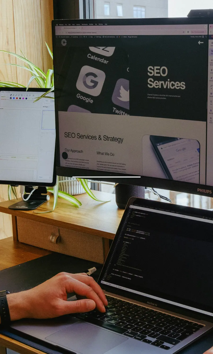 A digital marketer working on SEO strategy and website optimization across multiple monitor screens.