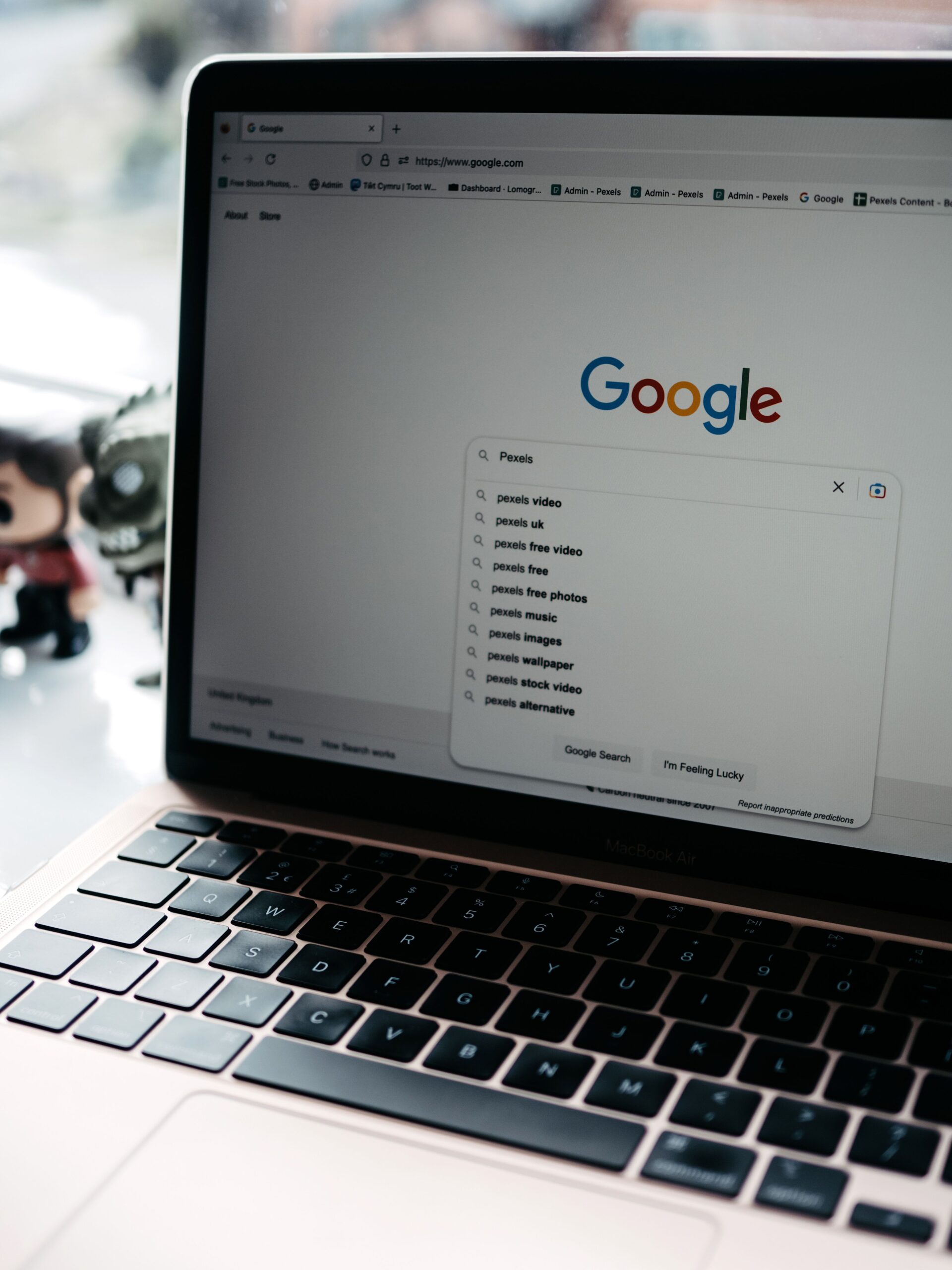 A close-up shot of a laptop displaying a Google search page with related searches visible.